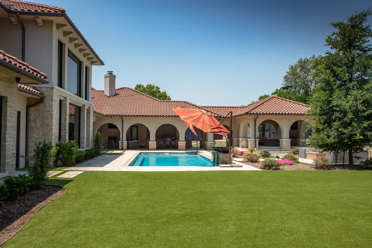 Artificial Turf Backyard in Austin with a swimming pool and a large seating area