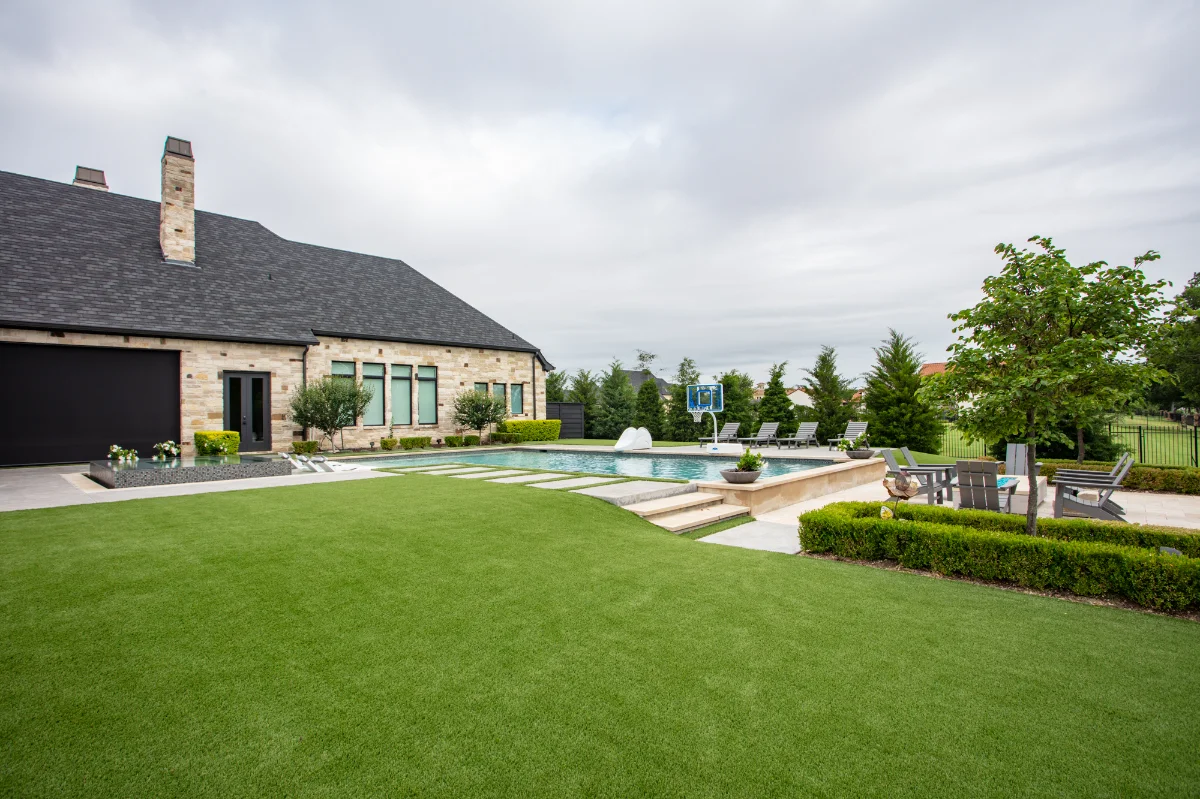Artificial Grass Yard in Jacksonville with a pool and paver fire pit area