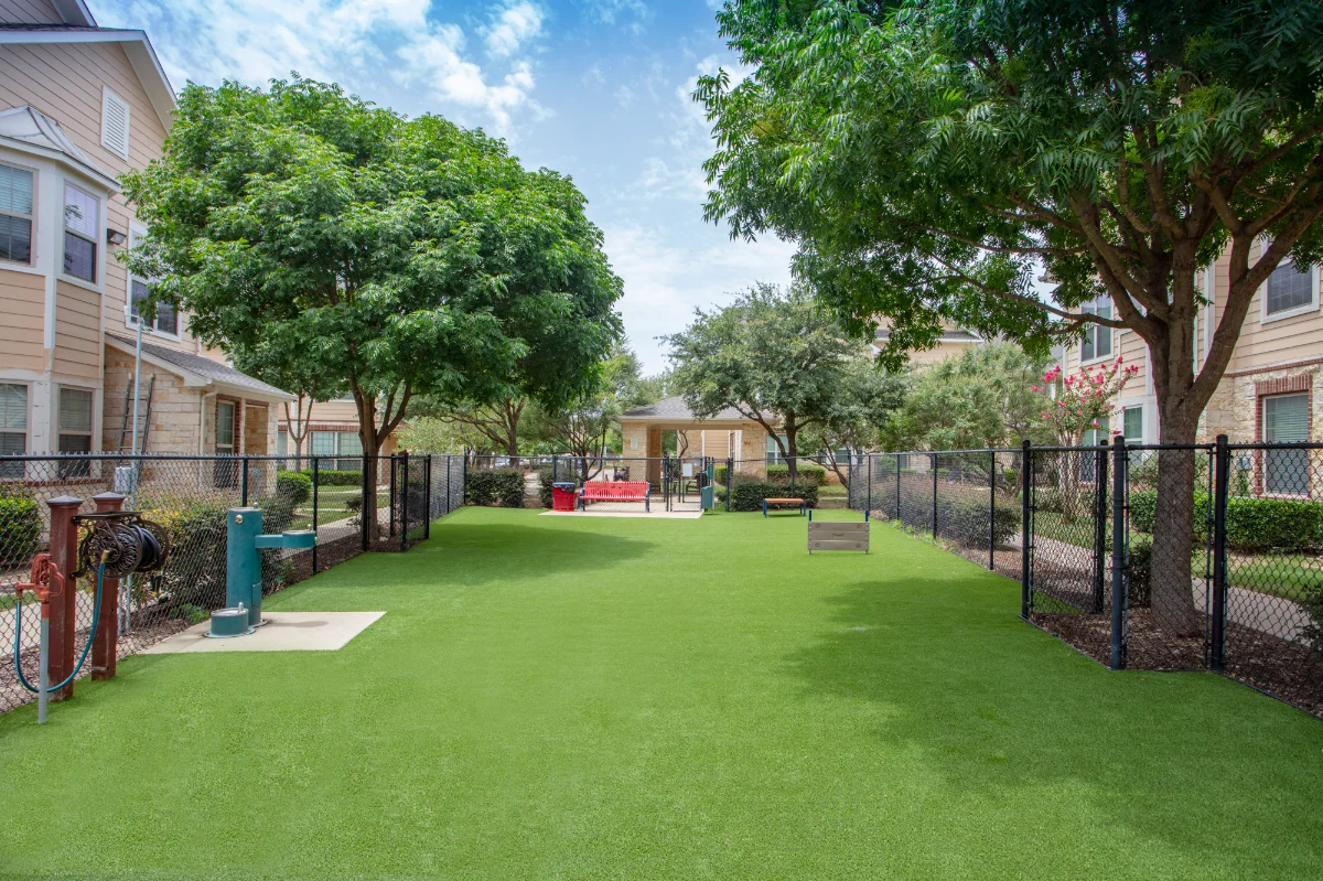 Artificial Turf Dog Park in an apartment complex with water fountains and toys