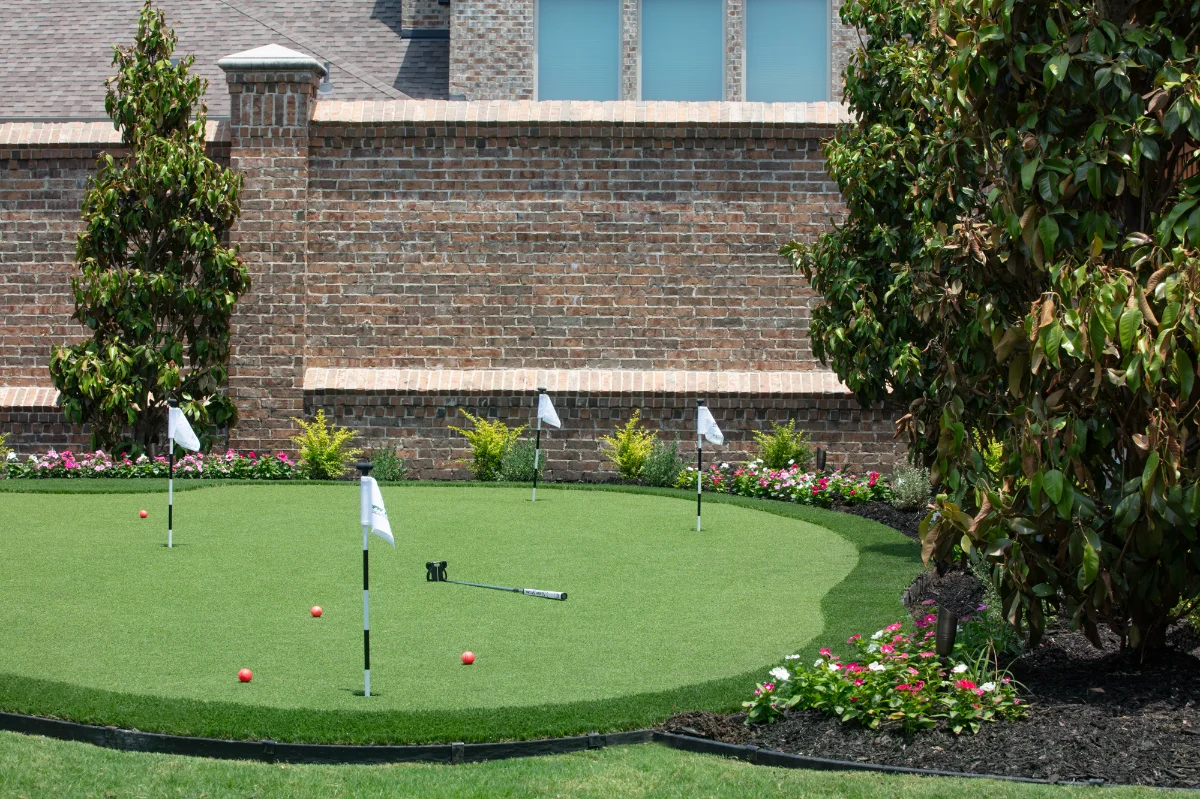 Backyard Putting Green in Austin with 4 hole and a flower bed