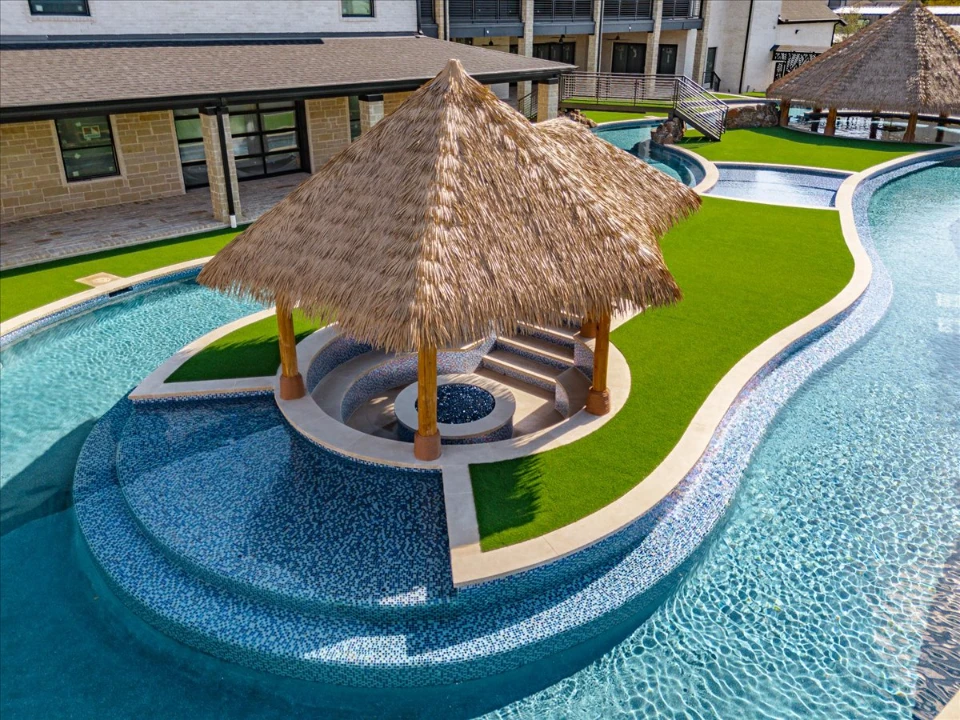 Synthetic Turf Yard in Austin with a lazy river and a firepit