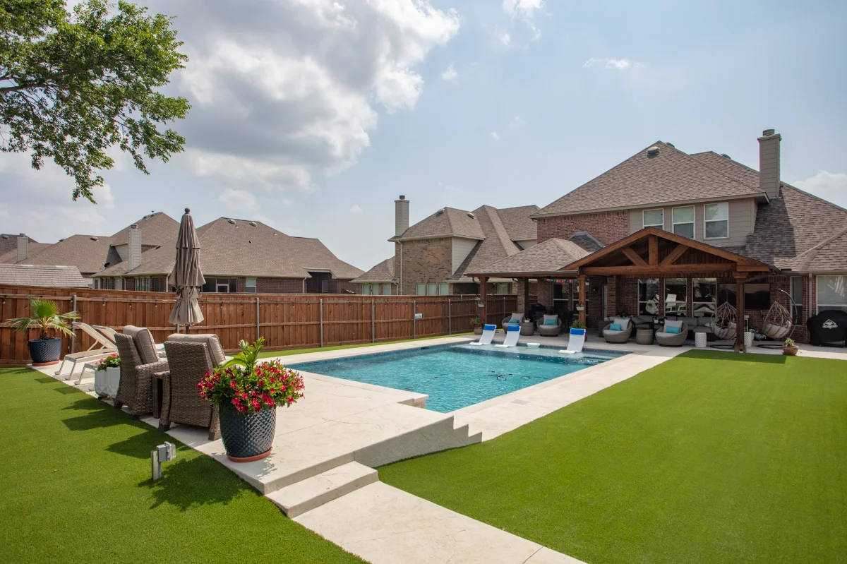 Synthetic Pet Turf Synthetic Pet Turf lawn with a pool and outdoor seating area