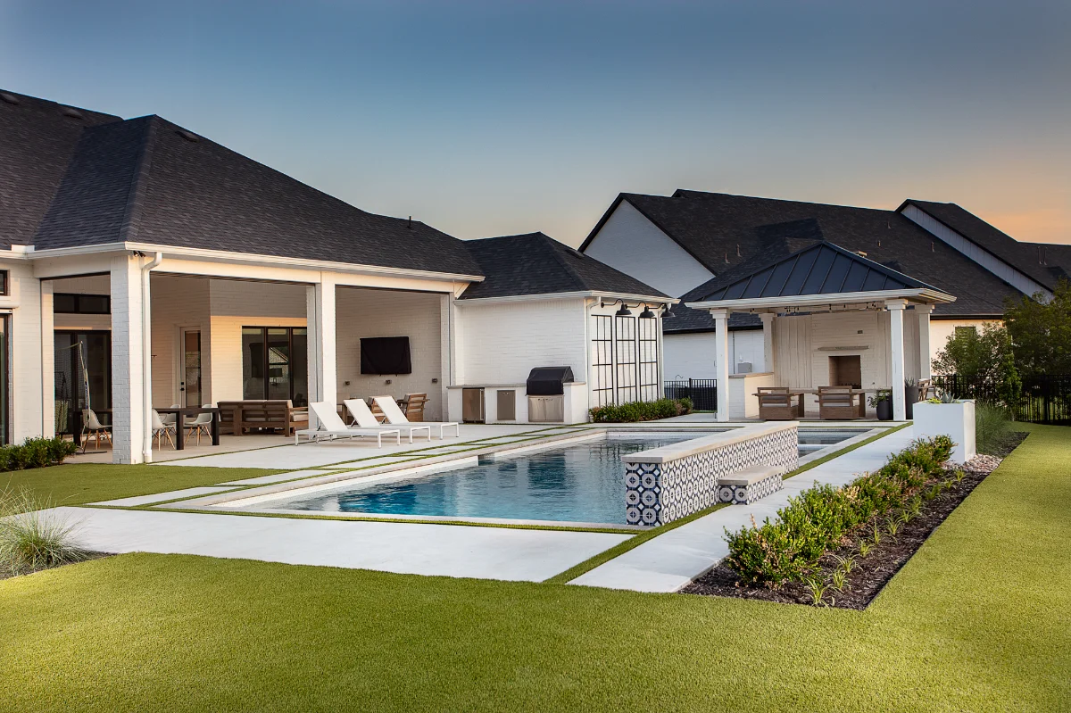 Artificial Grass Backyard Artificial grass lawn in a backyard with a pool and patio
